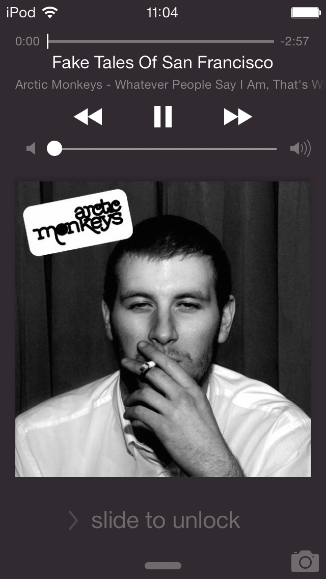 Screenshot of the lock screen of an iPod Touch while music is playing. It's displaying the cover of the album 'Whatever People Say I Am, That's Who I'm Not', by The Artic Monkeys. The cover is filling the entire screen.